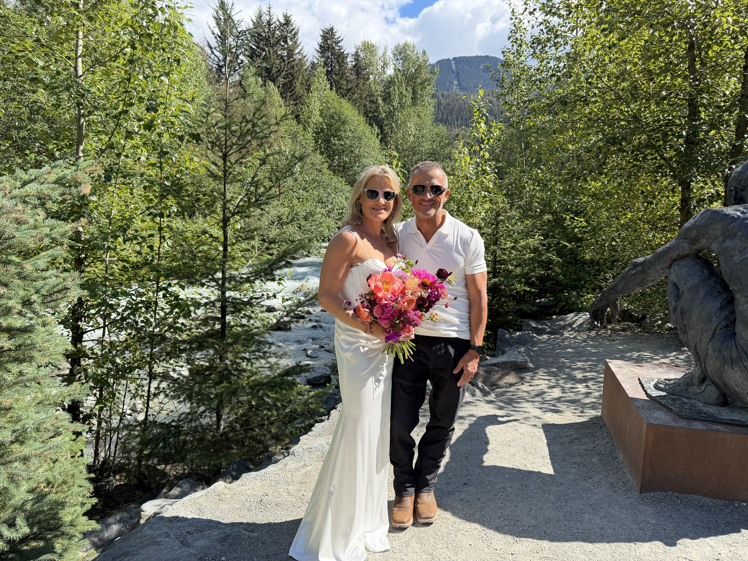 Daryl embracing Deb beside the river