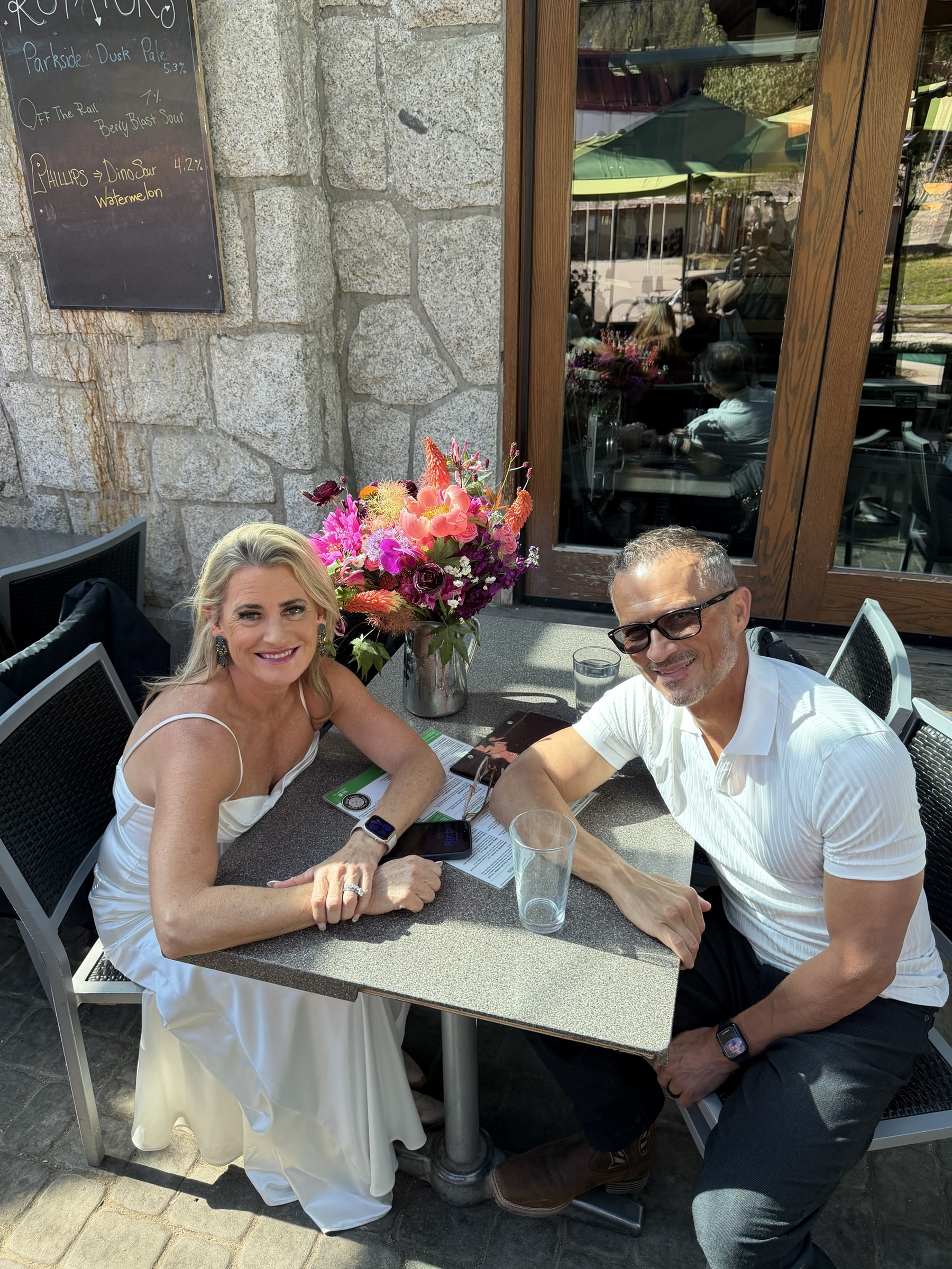 Deb and Daryl celebrating together at a café table